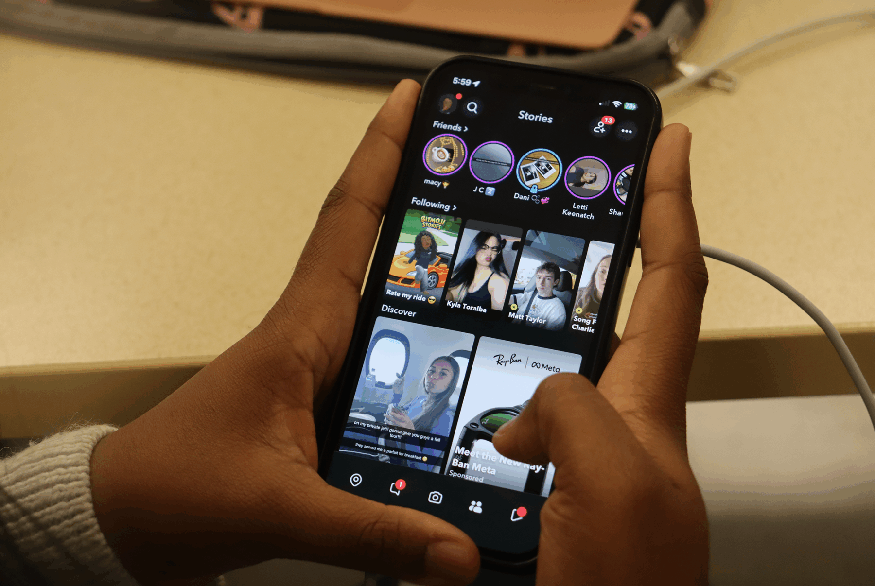 A photo of someone opening their phone to Snapchat's feature page