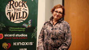 Cindy Beauchamp posing outside the theatre in front of the Rock the Wild sign prior to the concert