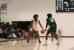 P-J Hacksaw performing a crossover during his game against the Durham Lords on Oct. 31, wearing the Wolves' white jerseys.