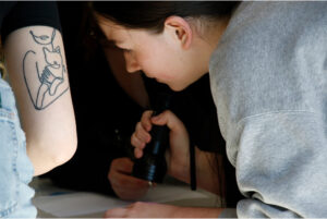 Kaitlyn Abernethy uses a blue light flashlight to find coordinates on Oct. 28th.