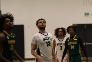 Gezim Pjetergjokaj is shooting free throws during his game against the Durham Lords on Oct. 31, wearing the Wolves' white jersey.