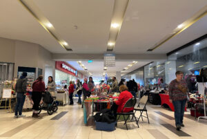 Shoppers browse tables of local makers at Merivale Mall during the Holly Jolly Christmas craft show.