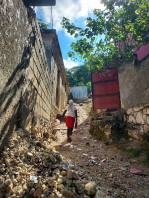 Neighbourhood in La Plaine, Port-au-Prince. Alexandre tries to display the living conditions in which him and his neighbours are subject to.