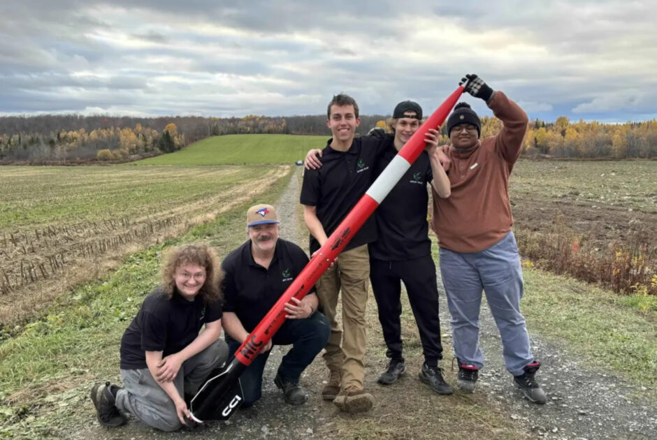 Members of Algonquin College Rocketry pose with Kratos after completing their first successful flight at the Ciel d’Octobre event in Saint-Camille, Que.
