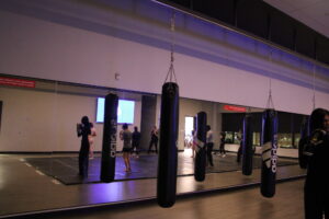 Students in their boxing stances, arms raised and eyes on Julie Parker as she demonstrates the jab during the Nov. 27 class.