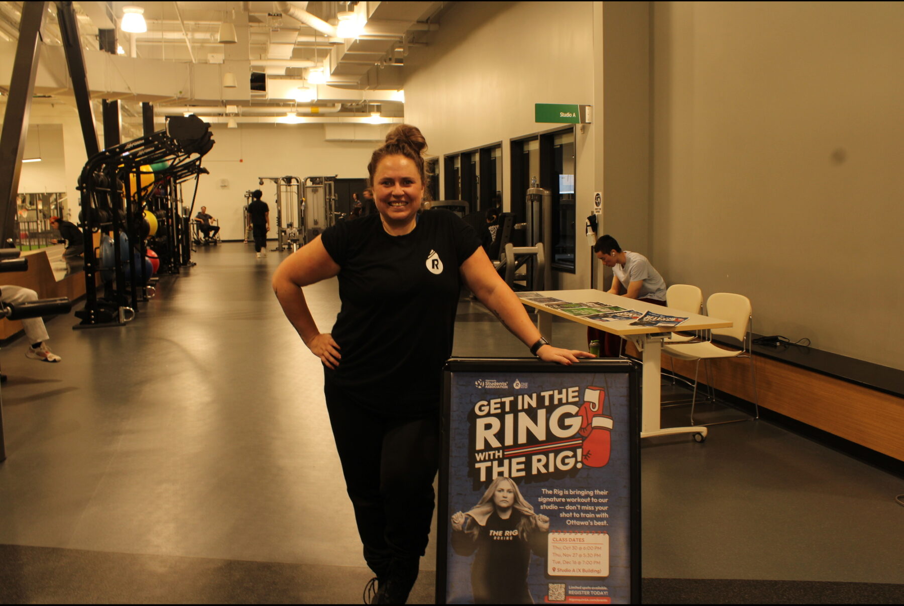 Julie Parker, coach and studio manager at The RIG’s Southpaw location, poses by her poster after the second boxing class on Nov. 27 at the Jack Doyle Athletics and Recreation Centre.