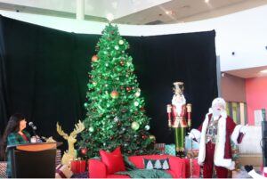 Santa smiles as the annual christmas tree is brought to life in the E building