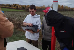 Team Captain Nathaniel Rolland prepares Kratos for inspection before flight, assisted by other team members.