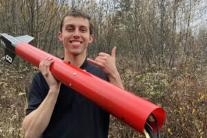 Team captain Nathaniel Rolland holds Kratos as the Algonquin College Rocketry team recovers the rocket after its flight and landing.