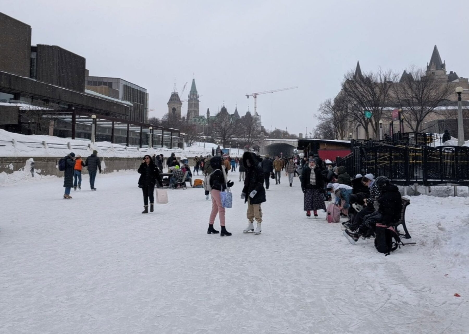 Rideau Canal, winter 2025, where people are walking around with both skates on and off.