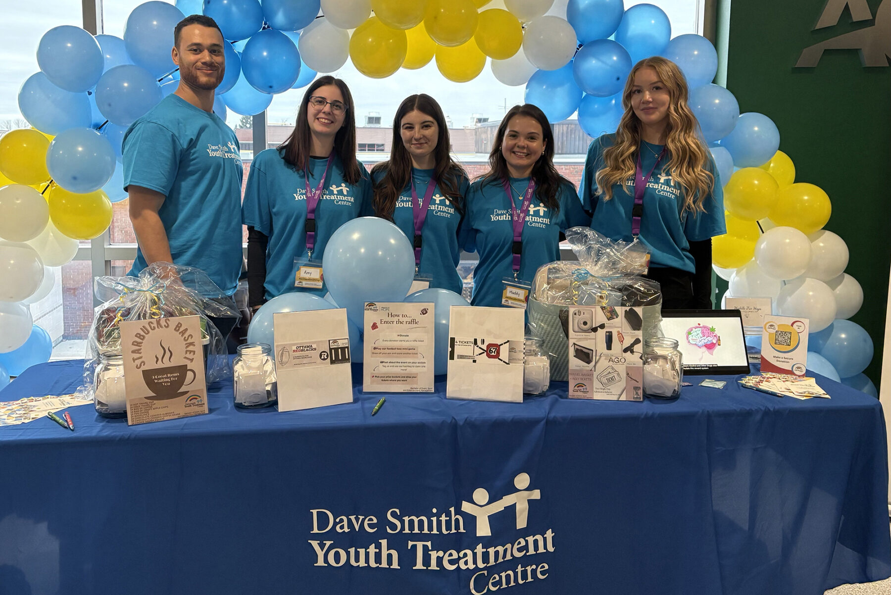 A booth in J-Building for the charity event selling raffle tickets to students and offering a chance to play mini football to win an extra ticket.