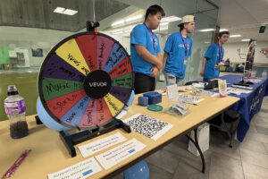 Wheel of fortune game at a booth in C-Building.