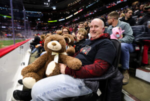 Family prepared to toss the teddy bear on the floor.