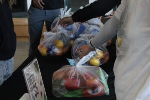 Students reach for fresh food bags at Fresh for $5 sale in the Student Commons on Jan 22.