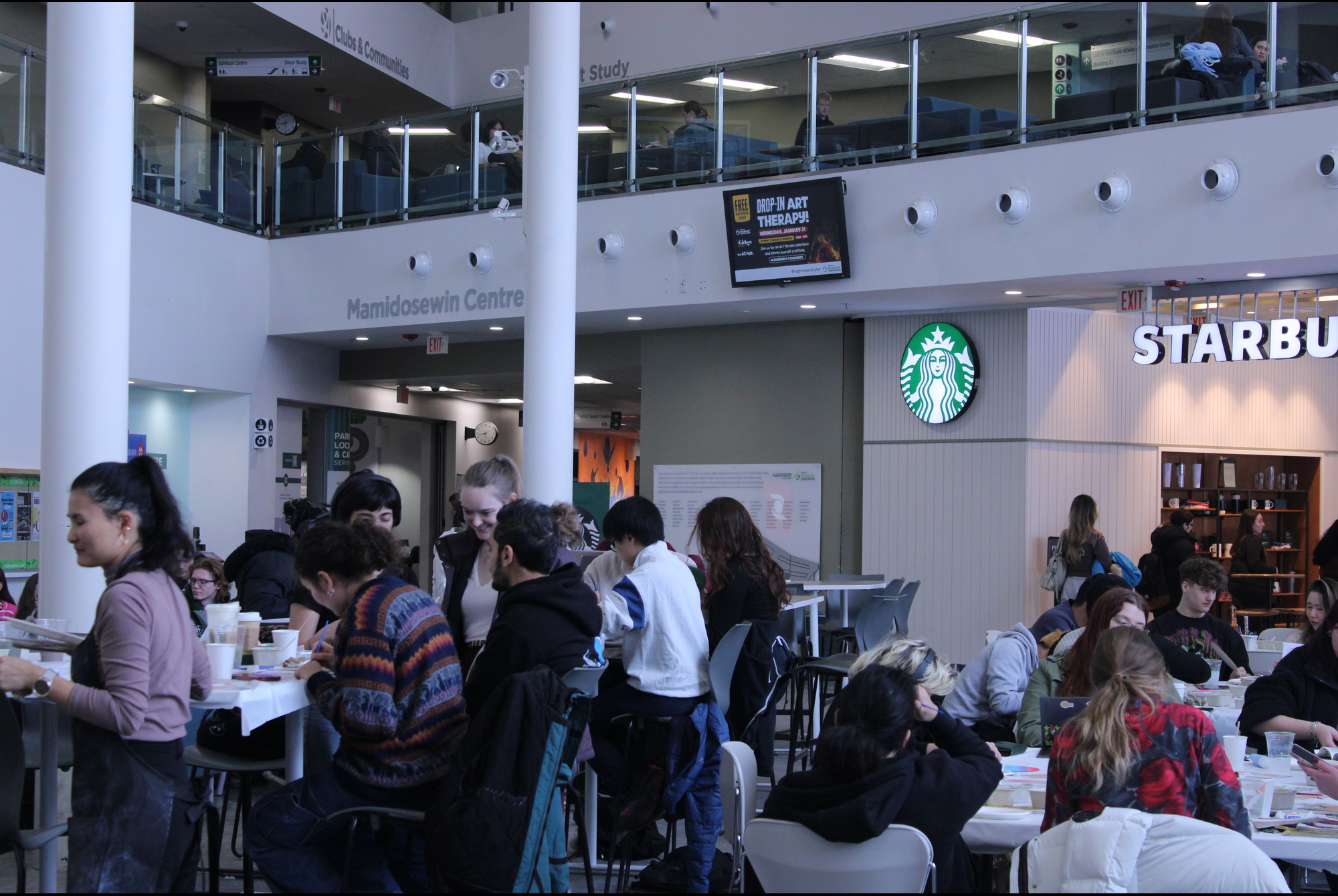Student Commons packed with students socializing and making art.