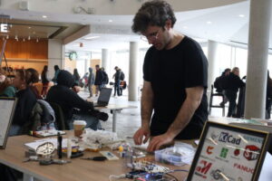 Ryan Walsh, one of the organizers of the manufacturing and electronics club, tables at Clubs Fest.