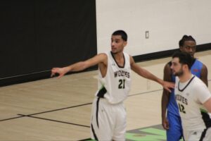 Algonquin Wolves forward Aydin Gilani coordinates with teammates on defence during stoppage in play against George Brown on Jan. 17 at the Jack Doyle Athletics and Recreation Centre.