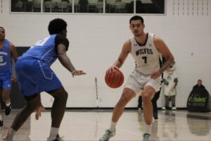 Algonquin Wolves guard Albert Opena dribbles the ball against George Brown on Jan. 17 at the Jack Doyle Athletics and Recreation Centre.