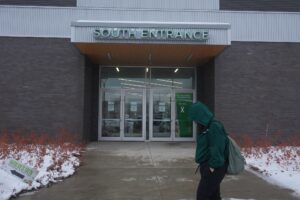 Student walks past the south entrance of the Jack Doyle Centre.