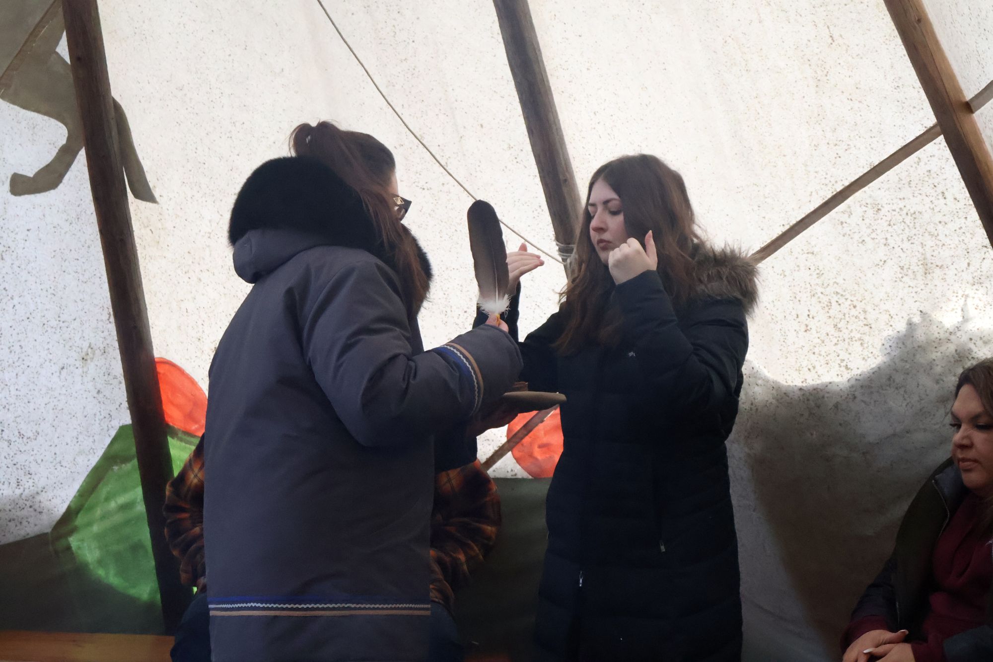 A student takes her turn smudging.