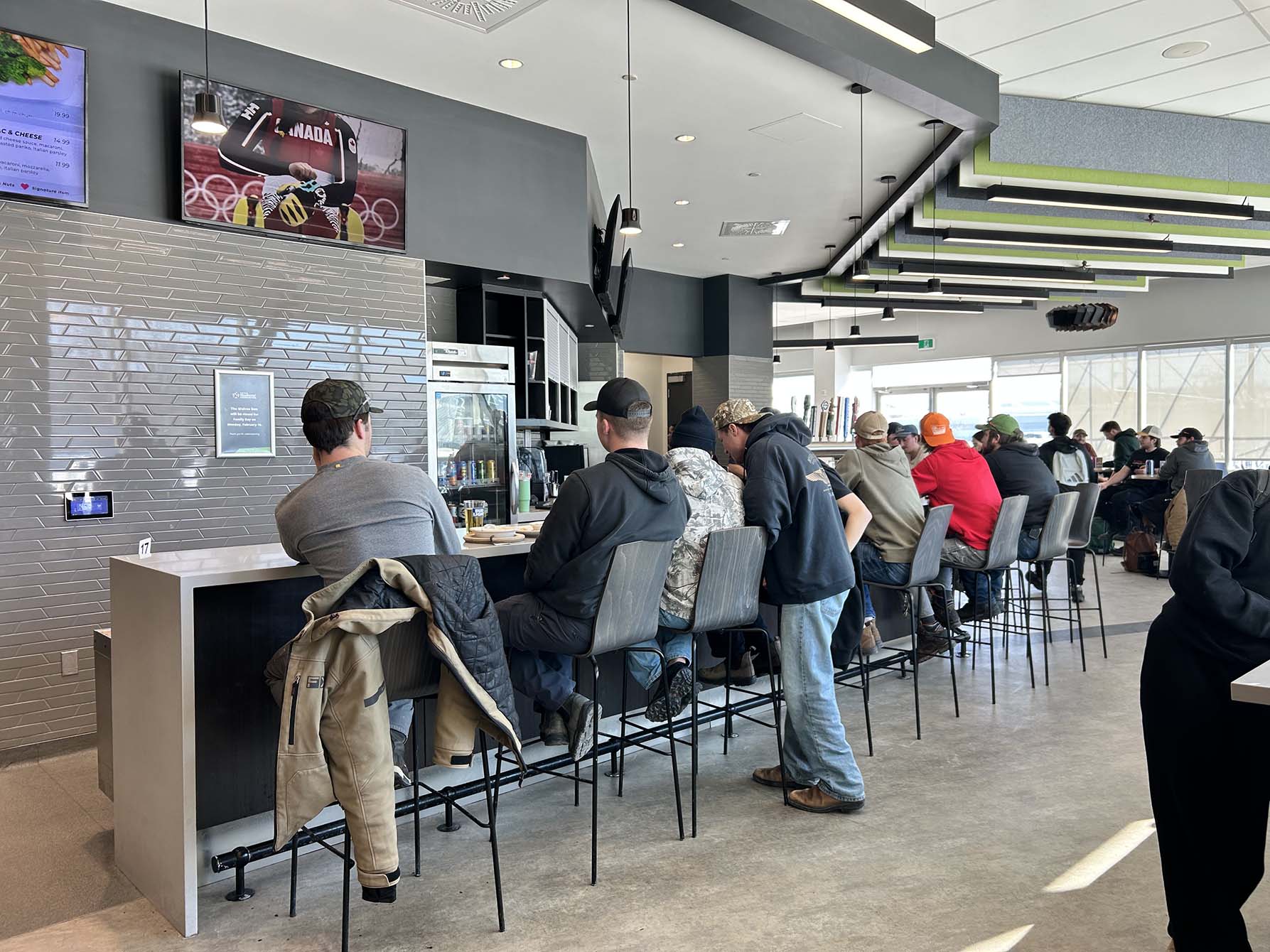 Students gathering at the Wolves Den to watch the Canada-Czechia men's preliminary hockey game.
