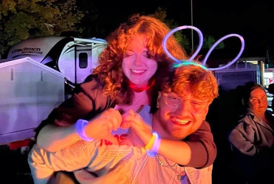 Photo of Damon Merrikin carry Grace Johnston on his back. Courtesy of Grace Johnston.