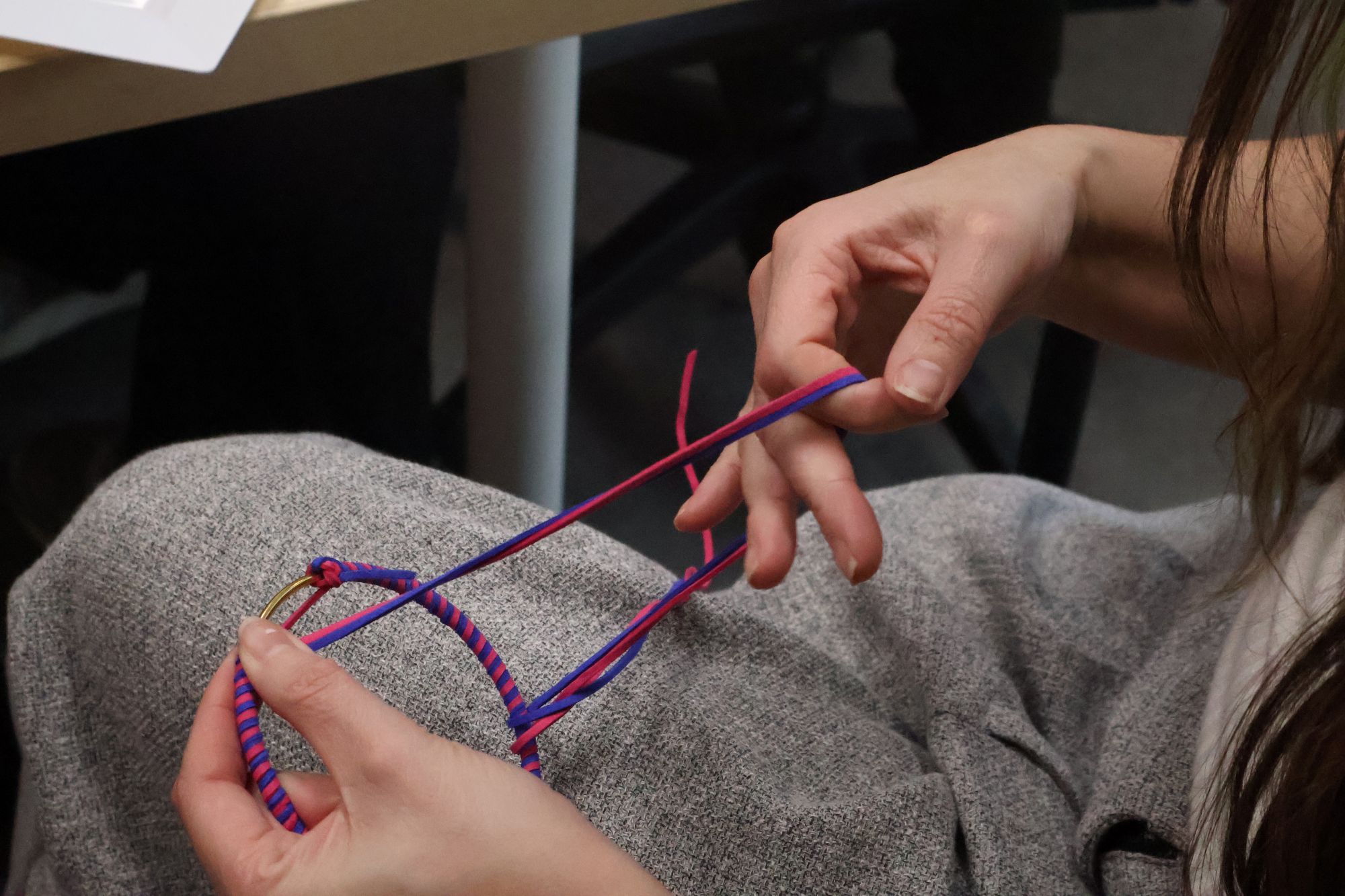 Geraldine Dion St-Pierre weaving thread around the metal ring, one of the fist steps to making a dreamcatcher.