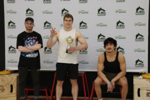 Winners of the men's bench press category at the Algonquin Wolves Powerlifting Competition stand at the podium on March 14. Left is Keenan Brewley, who came second, middle is Sebastein Ellis, who came first, right is Lennon Leyland-Pang, who came third.