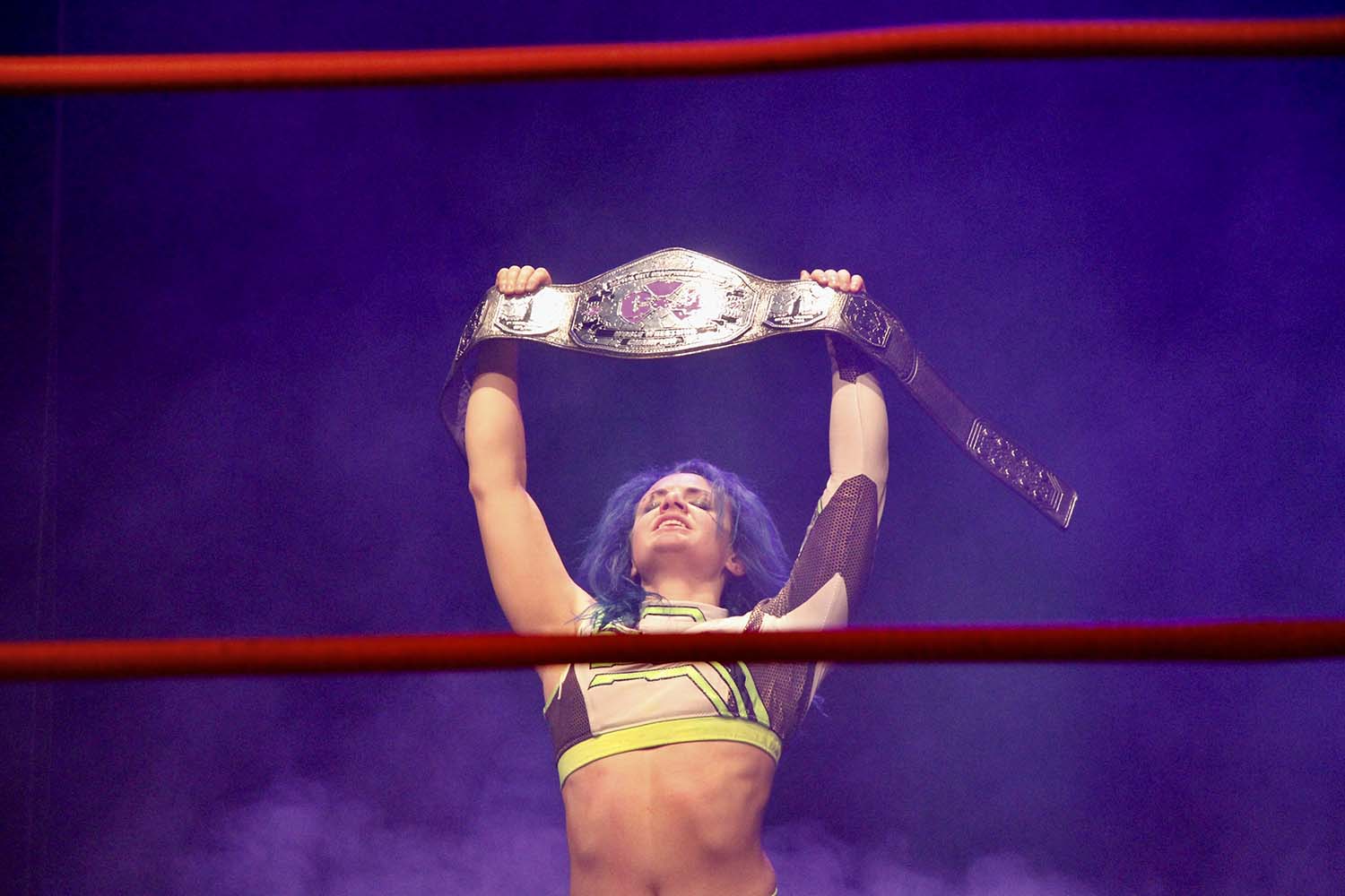 Alexia Nicole holds up the Champions Belt after being crowned the first-ever C4 Wrestling women's champion.