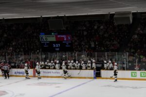 Kingston’s Nolan Snyder and teammates celebrate with bench after scoring goal on March 27, 2026 at TD Place