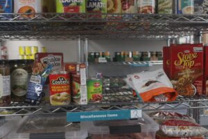 A shelf at the Algonquin College Food Cupboard stocked with a variety of food items for students to choose from.