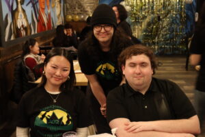 Sarah Siu (left), Nathan Legros (centre) and Raymond Bowers (right) greeted attendees at the registration table, sharing information about the Culture2Culture campaign and OCISO.