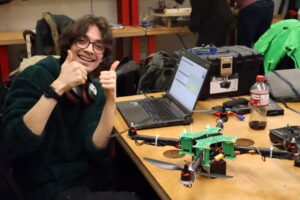 Drones designated flyer, Haeden Fethi-Henriquez, optimistically working on the drone after a failed flight attempt.