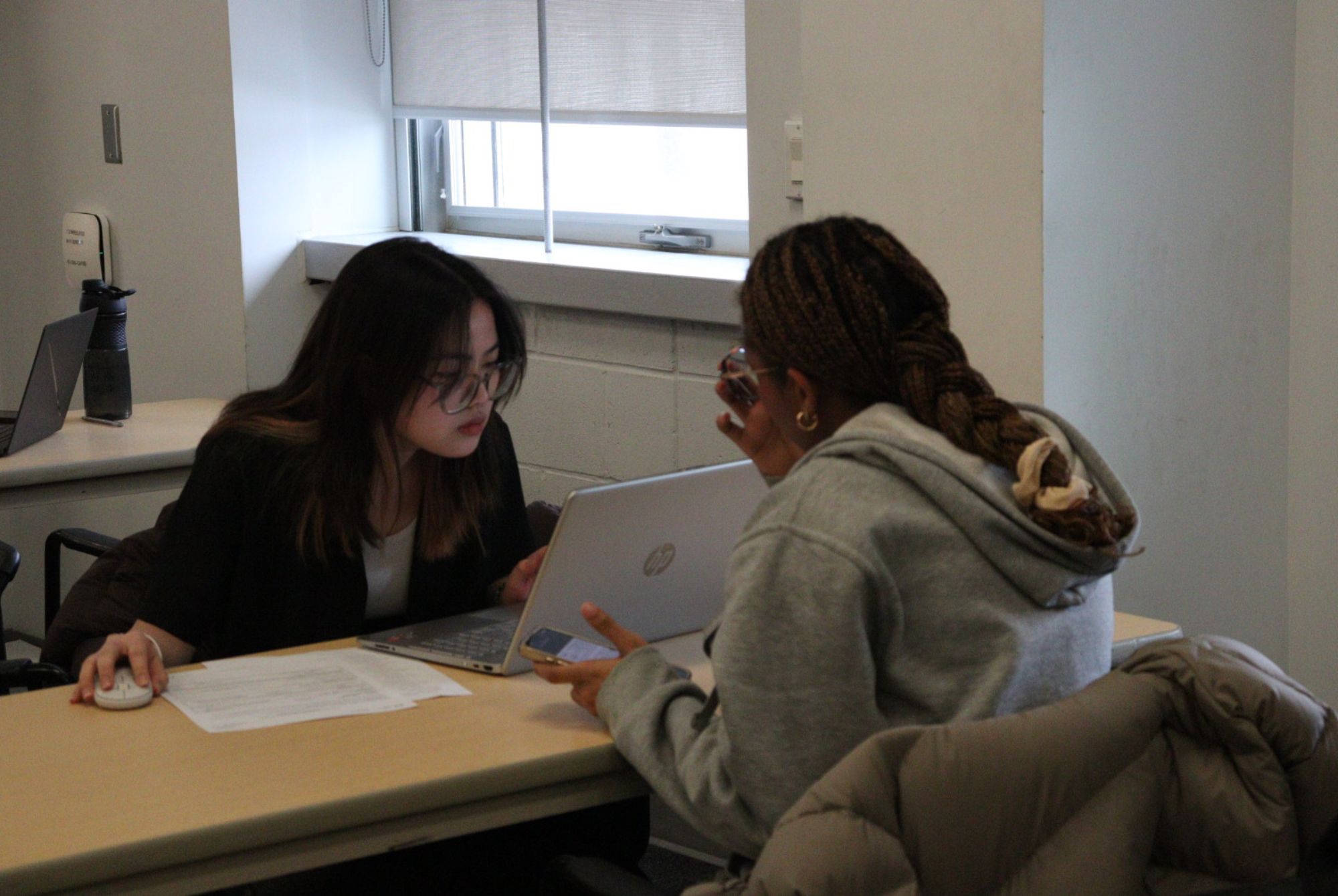 A volunteer helps a student file her taxes at the Algonquin College tax clinic in the CA-building on April 7.
