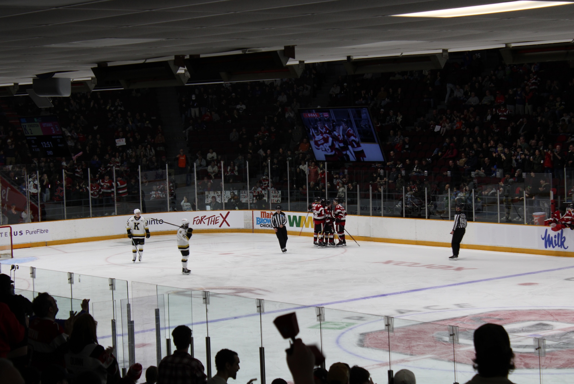 Nic Sima scores a power-play goal and celebrates with linemates at TD Place on March 27, 2026 during Game 1 of the first-round series.