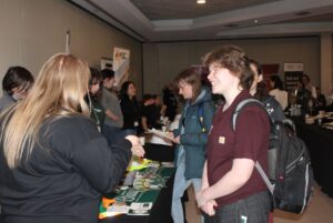 Attendees network and check out booths set up by companies including McDonald Brothers Construction Inc. and CGI.