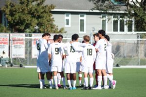 Algonquin Wolves men's team in a huddle awaiting the second half of the game to commence