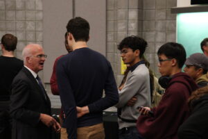 Like the other candidates, Jeff Leiper (second to far left) stayed back after the debate concluded to chat with students