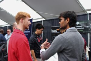 Dwij Brahmbhatt (right) explained the club's projects to eventgoers, hoping to spark interest.