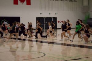 The tryouts started with a guided stretch and exercise session to get everyone moving.