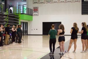 Sissi Malula, the head coach and coordinator of the team, gave an encouraging speech to the nervous cheerleaders.