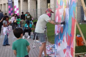 A child watches Ryan Smeeton create his spray-painted mural celebrating Ottawa's 200-year-long history.