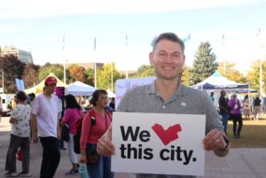 Aaron Taylor holds a sign which represents his love for the city which has given him so much already.