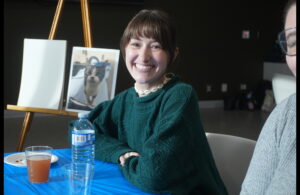 Level 3 Veterinary Technician student Riley Voisard smiles while seated at the painting table during the “Snack and Paint” fundraiser in support of Rideau Valley Wildlife Sanctuary.