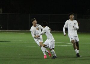 Matin Ljajic smiling at Cristian Aviles-Molina after giving the Wolves their first lead in the playoff qualifier against the Redeemer Royals on Oct. 21