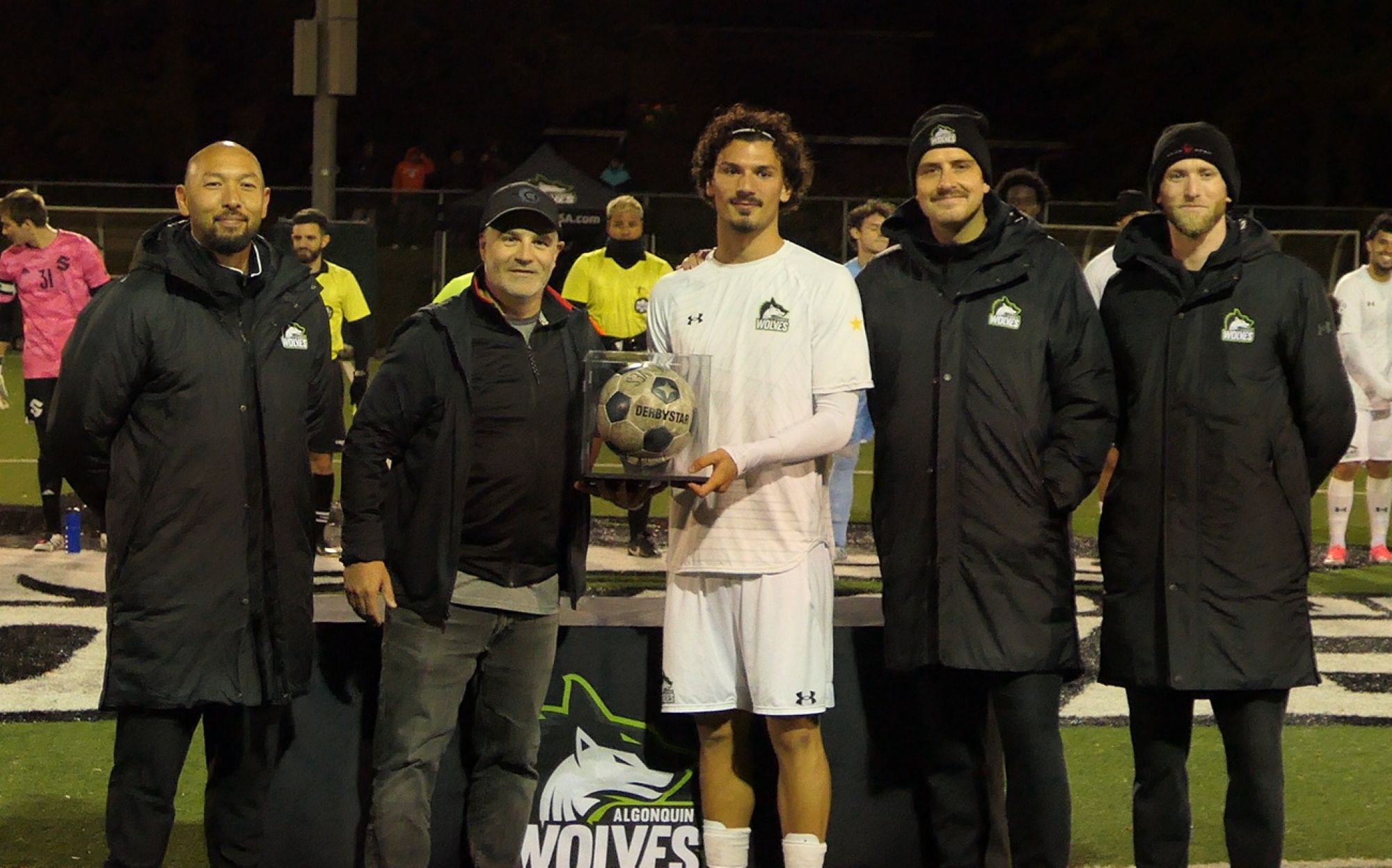 From left, Angus Wong, Mike Caruso, Alessandro Vivolo, Kieran Spring and Colin Gibson pose with Vivolo's game ball, awarded after he broke Caruso's record for most goals by an Algonquin Wolves men's soccer player
