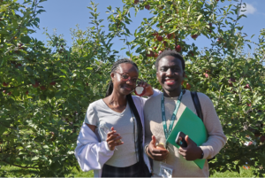 Tabitha Bogonko and Ilukena Maswenyeho show off their freshly-picked apples.