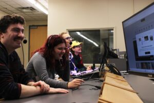 Noah Moors, Emma Faubert, Dade Dullemon and Jacob Deschamps taking a moment to laugh while looking at pre-production.