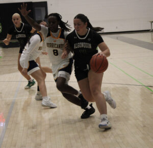 Guard Kaitlyn Harvey attempting to drive to the basket